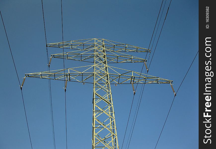 Pillar of the old high-voltage lines in the blue sky