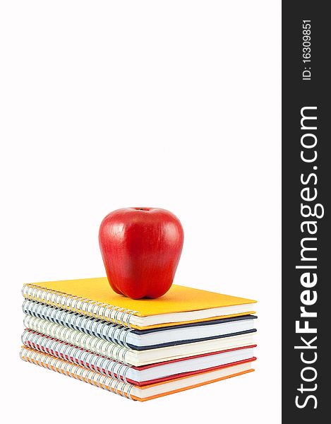 Red Apple Placed On Stack Of Note Book and Isolate On White background