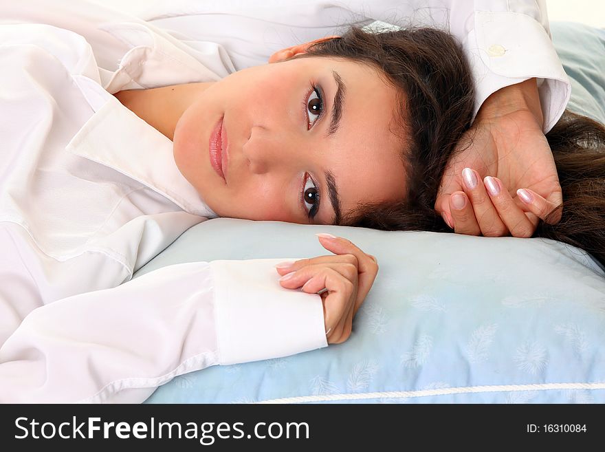 Happy Young Woman relaxing In Bed