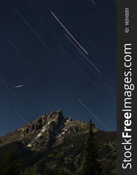 A shooting Star shoots across the sky over the grand tetons, Wyoming. A shooting Star shoots across the sky over the grand tetons, Wyoming.