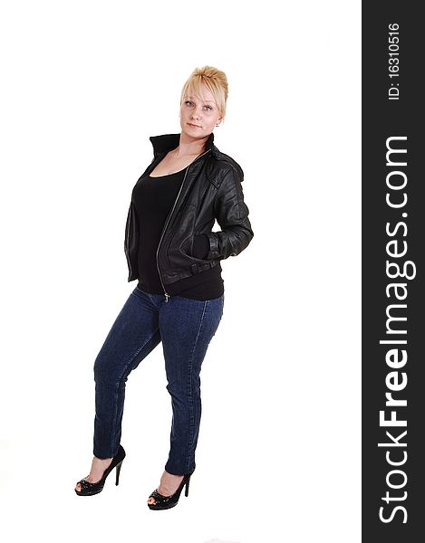 An pretty blond woman in jeans and a black tank top and leather jacket, standing in the studio, for white background. An pretty blond woman in jeans and a black tank top and leather jacket, standing in the studio, for white background.