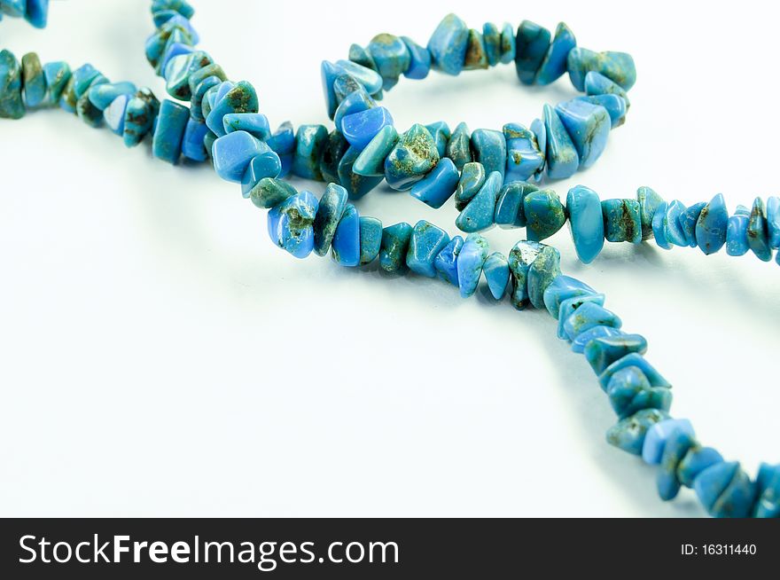 Blue necklace on a white background