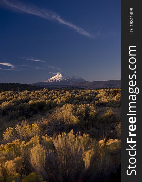 Sunrise with a large snow capped Mountain in the distance. Sunrise with a large snow capped Mountain in the distance