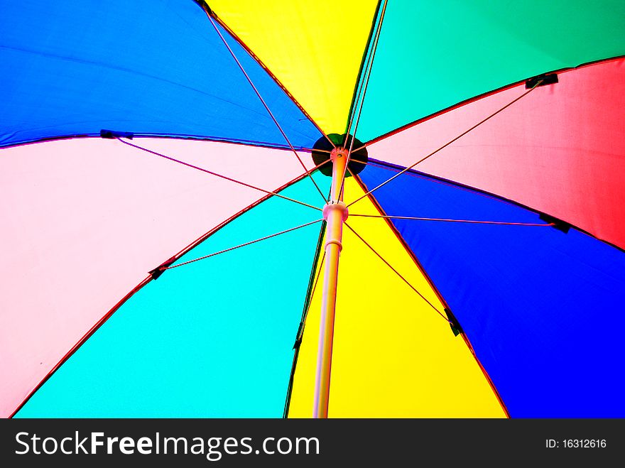 Under colorful beach umbrella