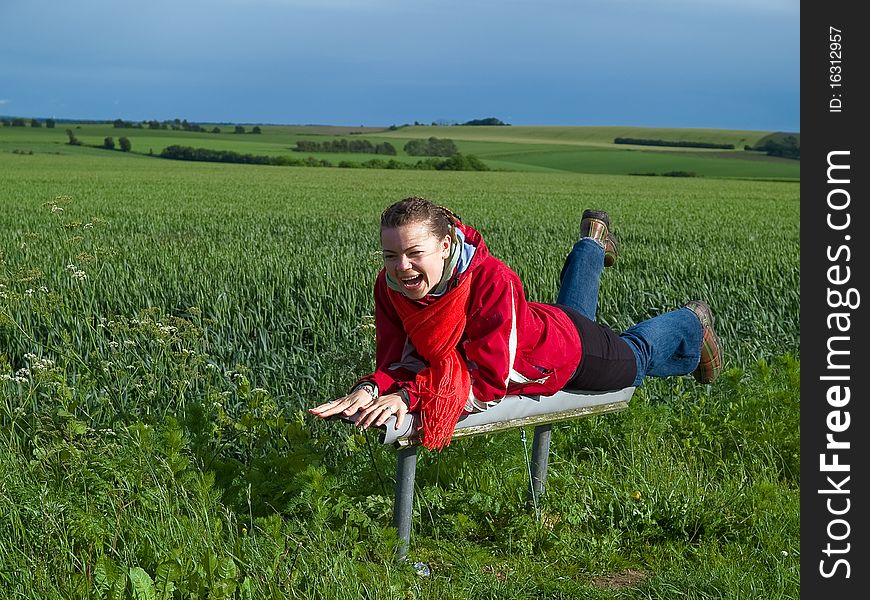 Beautiful attractive smiling young happy woman girl in a green wheat field. Beautiful attractive smiling young happy woman girl in a green wheat field