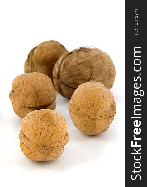 Five walnuts on white background