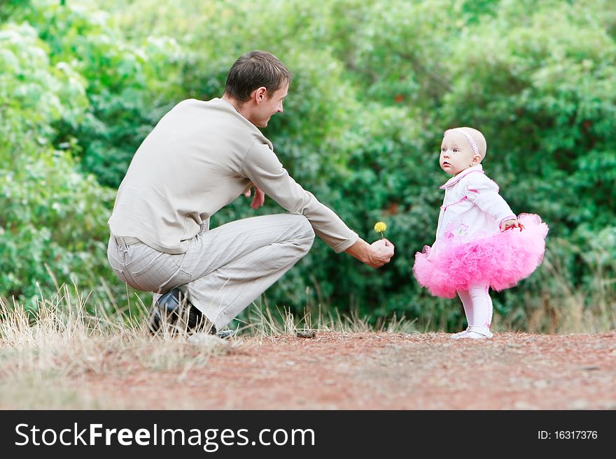 Father giving a flower to his daughter