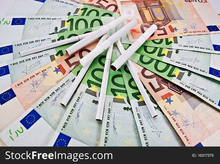 Scattered euro banknotes and cigarette. Scattered euro banknotes and cigarette