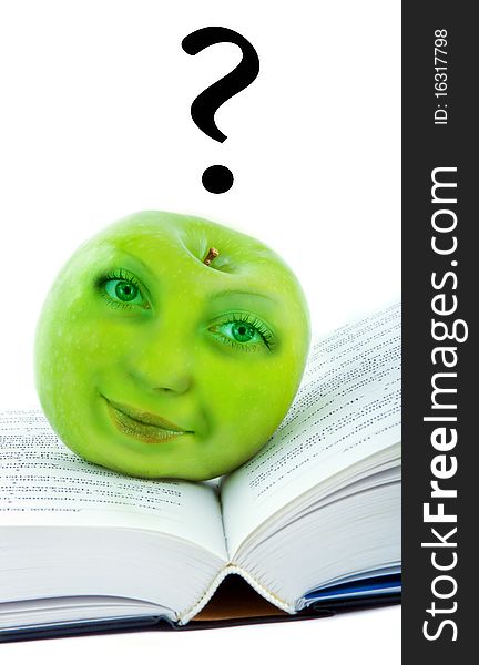 Green apple with the human face on the book. Green apple with the human face on the book