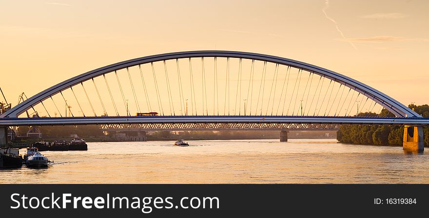 Modern bridge over river in sunrise. Modern bridge over river in sunrise
