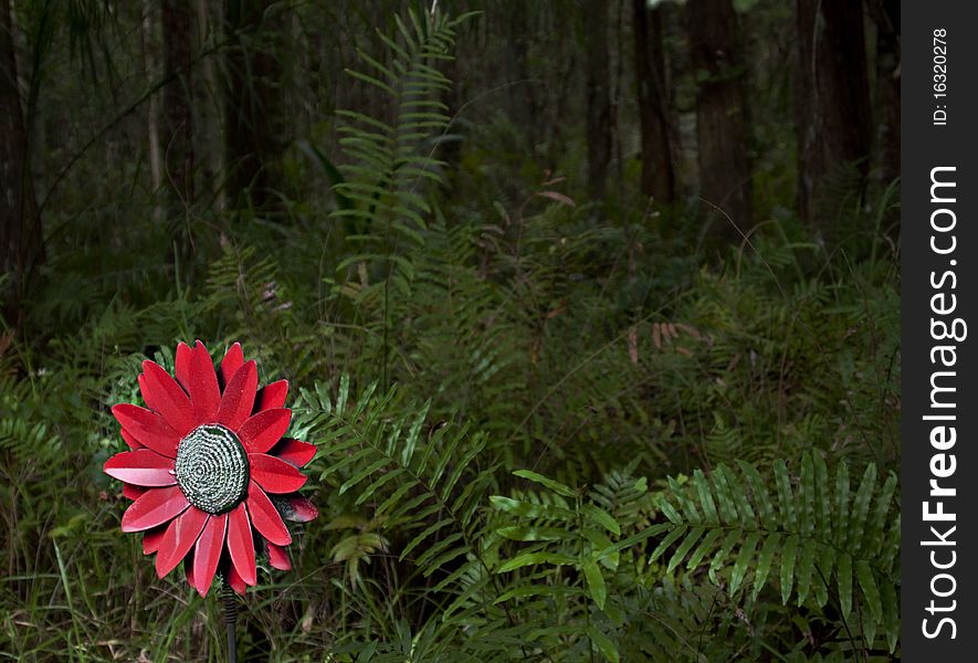 HRD photo image of a red fake flower in the forest. HRD photo image of a red fake flower in the forest