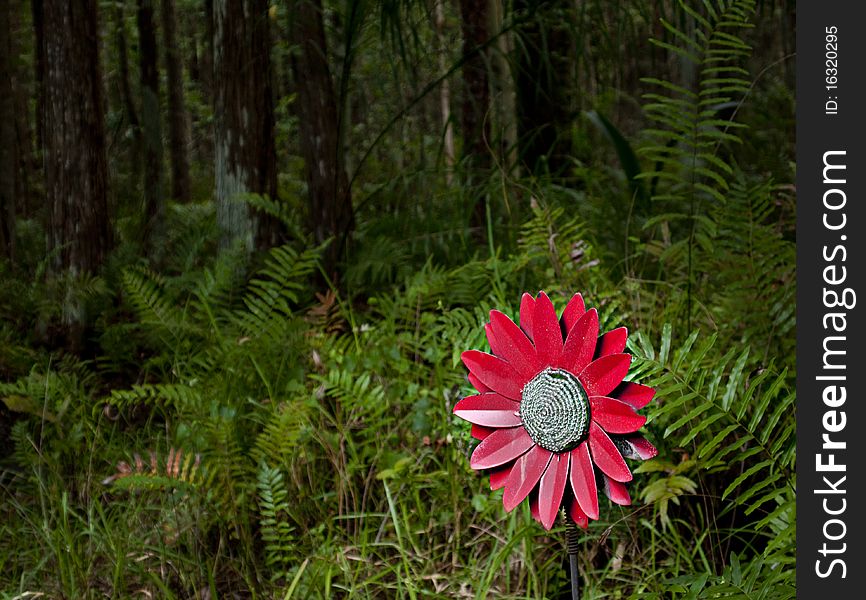 HRD photo image of a red fake flower in the forest. HRD photo image of a red fake flower in the forest