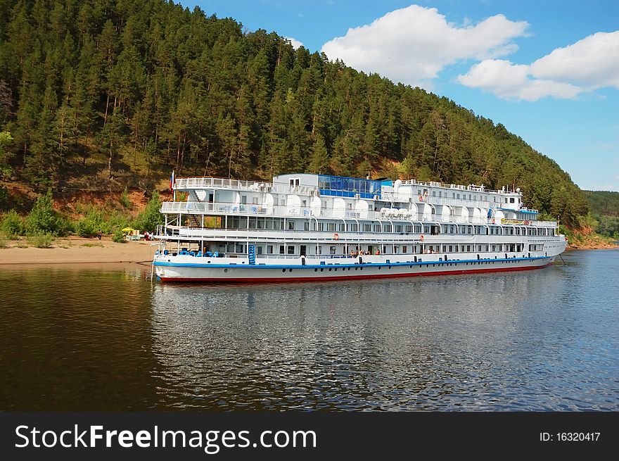 White river cruise boat with bank on a background