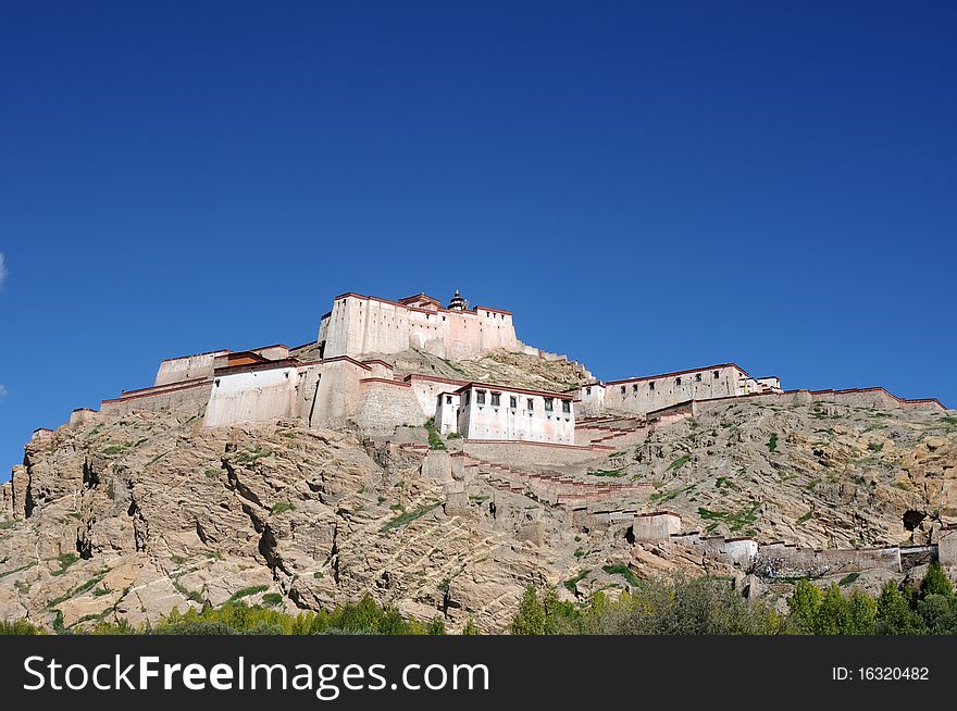 Scenery of an ancient castle in Tibet,with blue skies as backgrounds. Scenery of an ancient castle in Tibet,with blue skies as backgrounds.