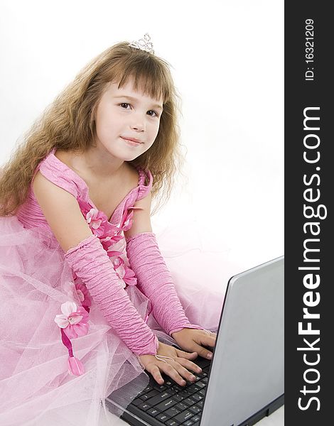 Little girl the princess plays with the notebook. White background. Little girl the princess plays with the notebook. White background