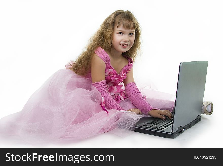 Little girl the princess plays with the notebook. White background. Little girl the princess plays with the notebook. White background