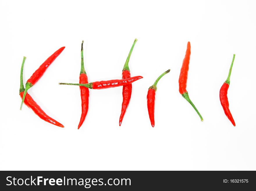 Letter made from red hot chili peppers isolated on seamless white background