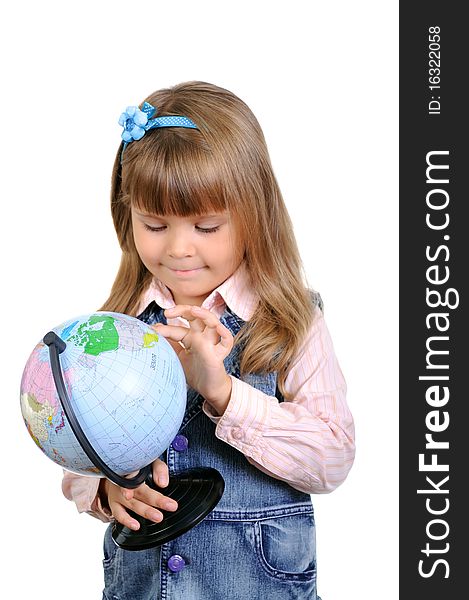 The little girl studies the globe