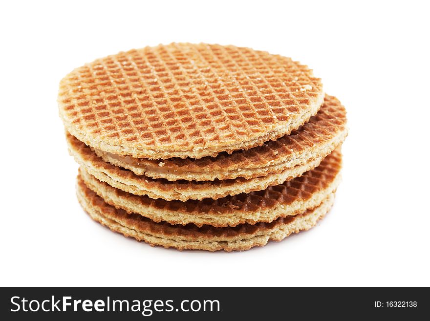 A stack of golden round waffles isolated over white background.