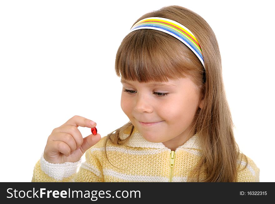 The smiling girl holds a medicinal capsule in a hand on white. The smiling girl holds a medicinal capsule in a hand on white