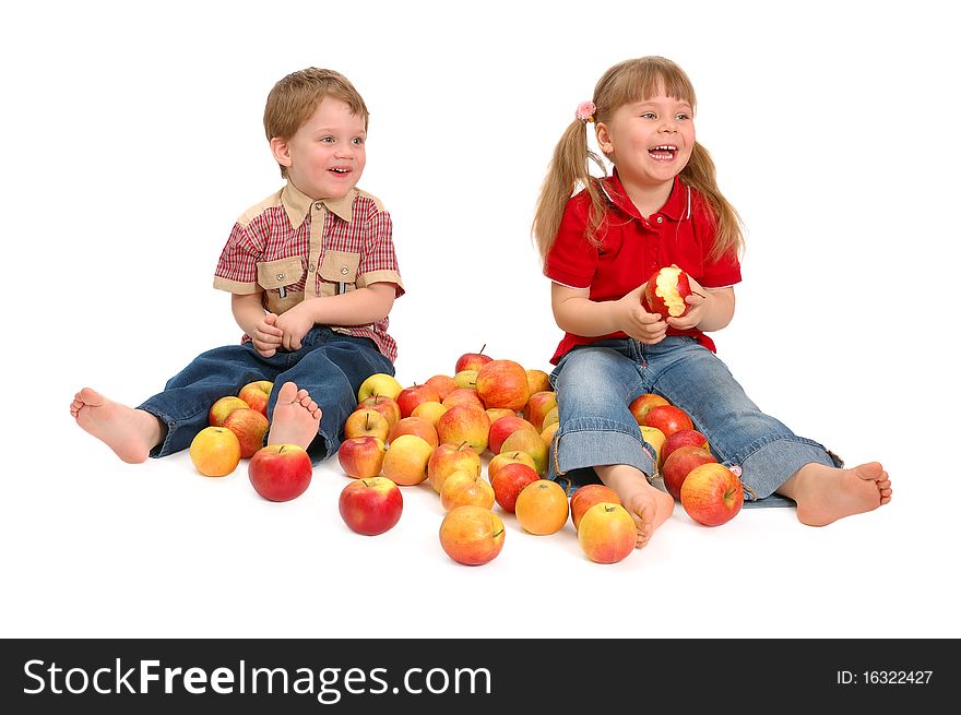 The boy and the girl with apples on the white