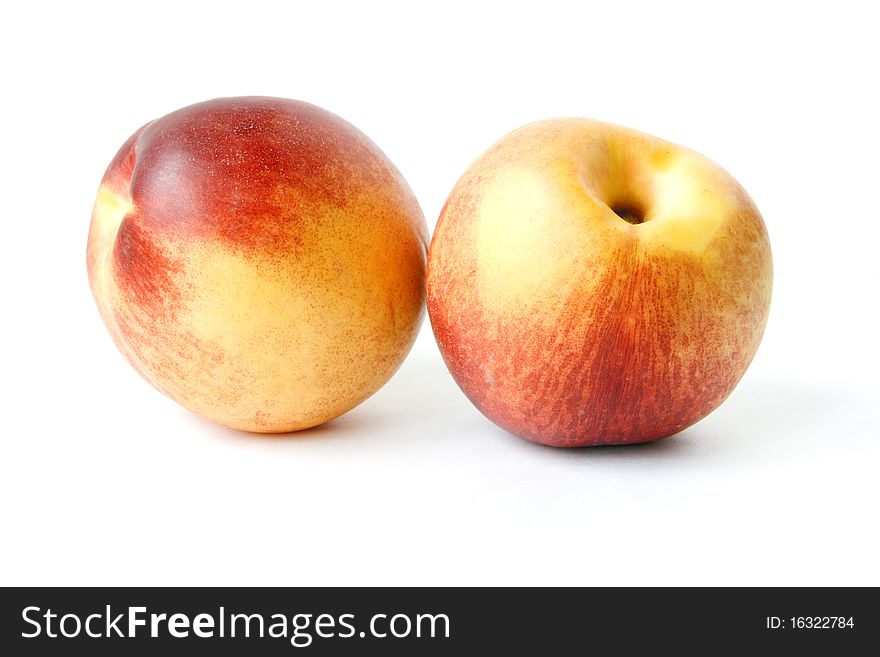 Two nectarines isolated on a white background