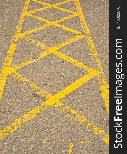 An image of an area marked out by yellow crossed lines where vehicles must not park and which must be kept clear. An image of an area marked out by yellow crossed lines where vehicles must not park and which must be kept clear.
