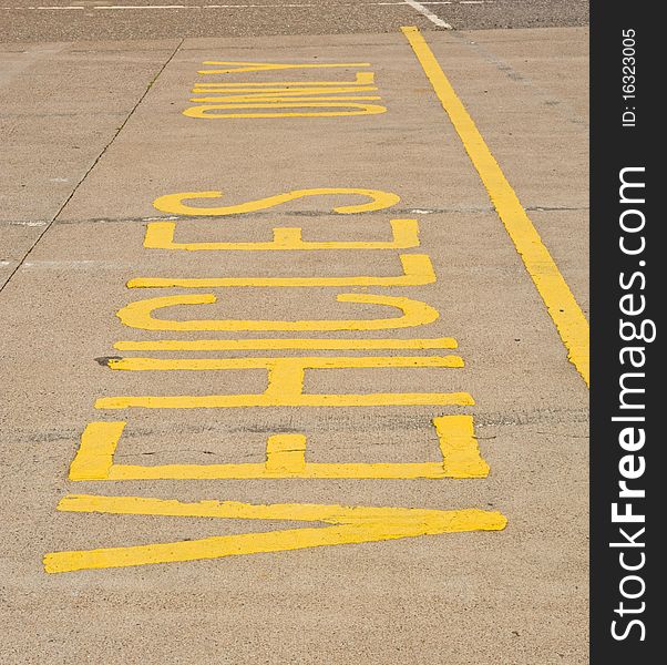 An image of a sign indicating ' vehicles only ' on the road outside a supermarket. An image of a sign indicating ' vehicles only ' on the road outside a supermarket.