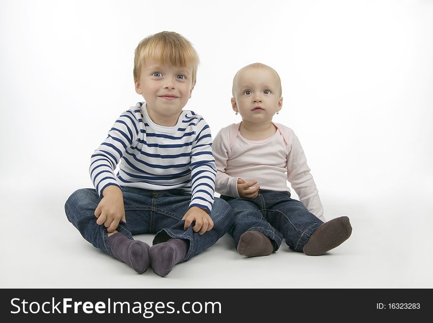 Brothers and sisters sit, on white background.