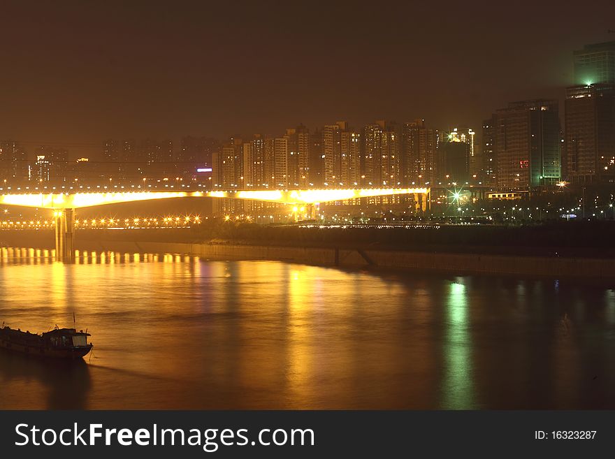 China mountain city - Chongqing, have a very beautiful night scene, bright river, bright building, shining Bridge. China mountain city - Chongqing, have a very beautiful night scene, bright river, bright building, shining Bridge