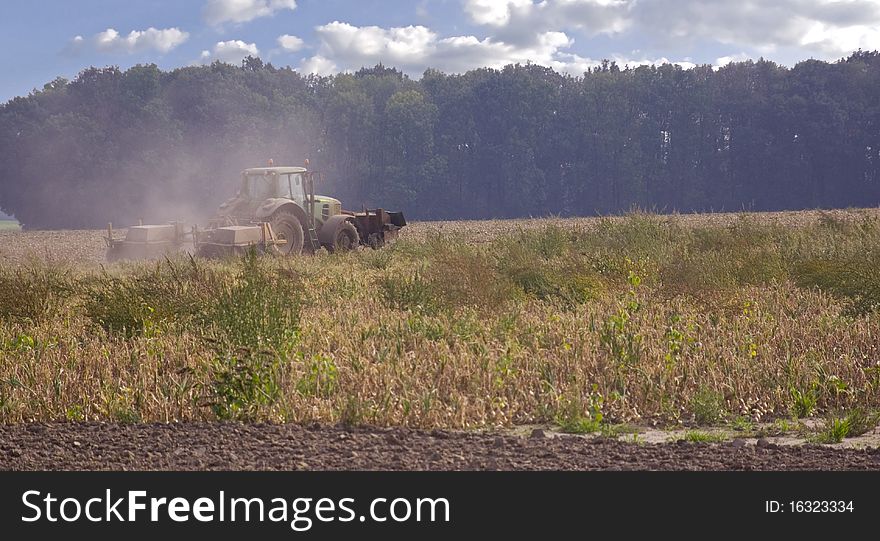 Tractor on a field, summer scenery