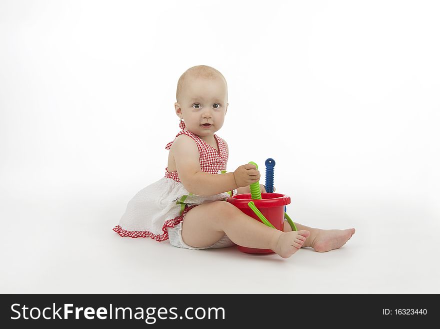 Baby with pail and shovel, on white background.