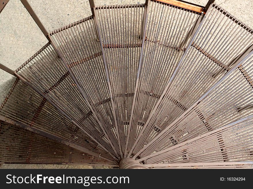 A spiral steel stair case texture descending. A spiral steel stair case texture descending