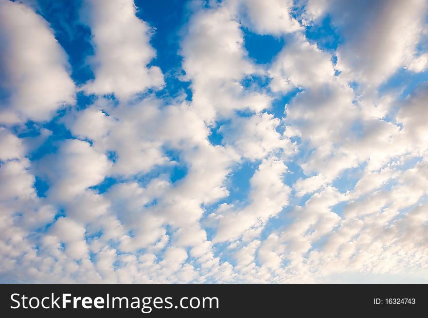 White fluffy cumulus clouds on a blue sky. White fluffy cumulus clouds on a blue sky