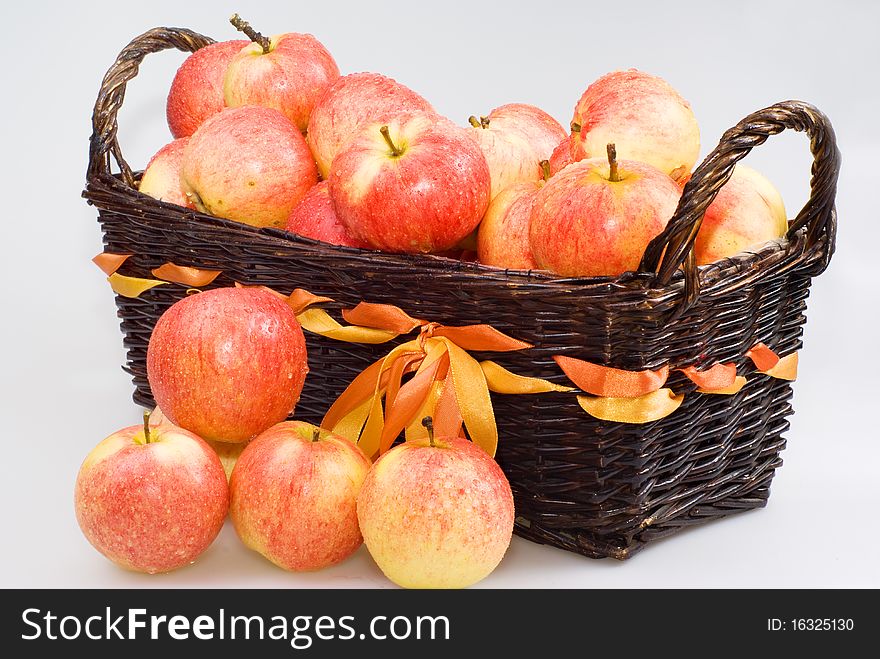Basket with apples on the white background