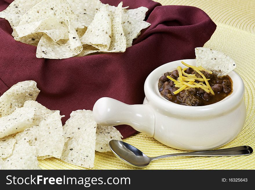 A hearty bowl pf chili and tortilla chips. A hearty bowl pf chili and tortilla chips