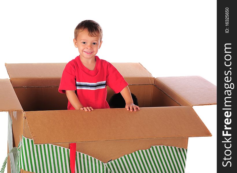 A happy preschooler playing in a giant-sized box with left-over Christmas wrappings.  His brother's head visible inside as well. A happy preschooler playing in a giant-sized box with left-over Christmas wrappings.  His brother's head visible inside as well.