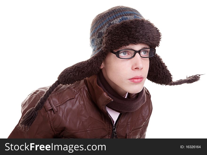 Young boy looking serious, with winter clothes and hat in the wind, isolated on white, studio shot