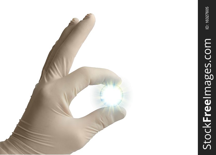 The hand in a medical glove holds a shining sphere