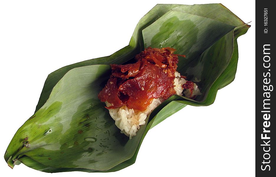 Sweet meat on sticky rice inside banana leaf package.