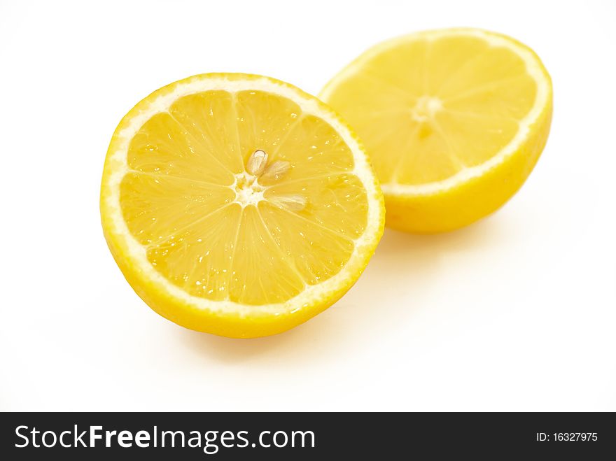 Two halves of lemon on a white background