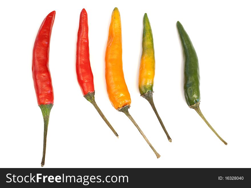 Multicoloured chili peppers isolated on white