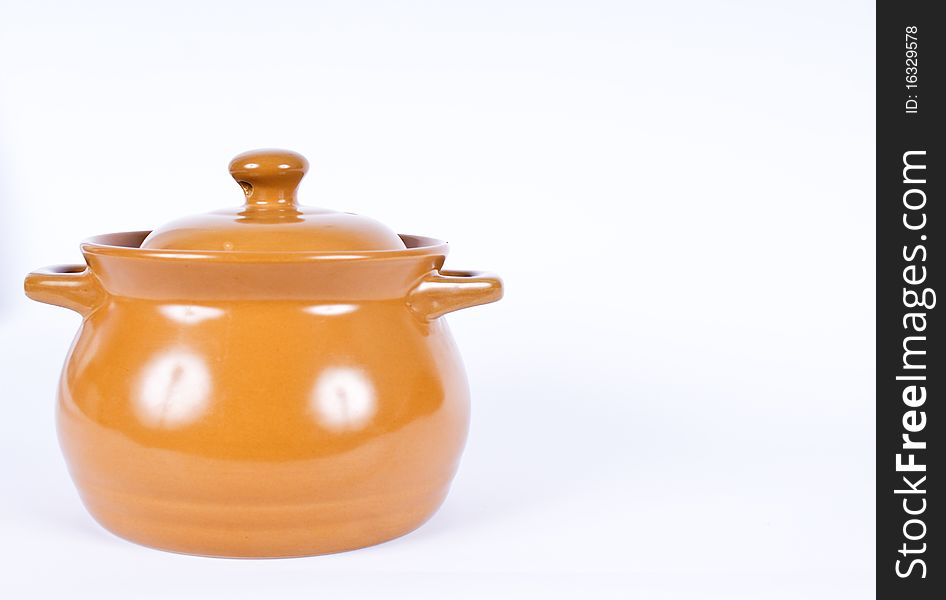 It is a shot of pot with lid on white