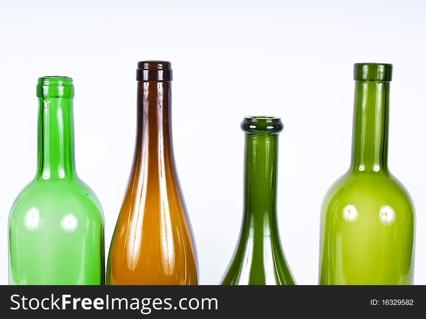 Four colored bottles on a white background.