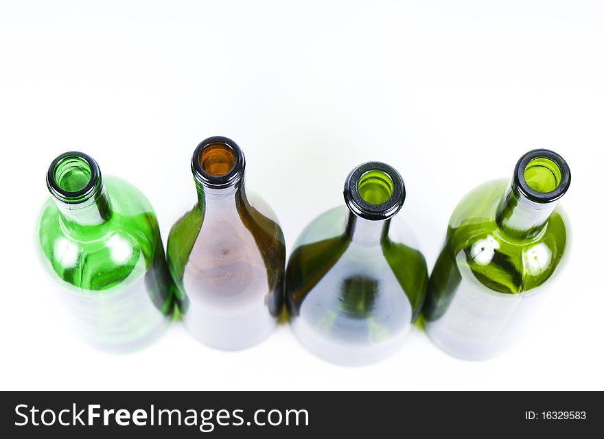 Four colored bottles on a white background