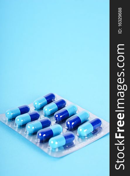 Medical tablets isolated on blue background