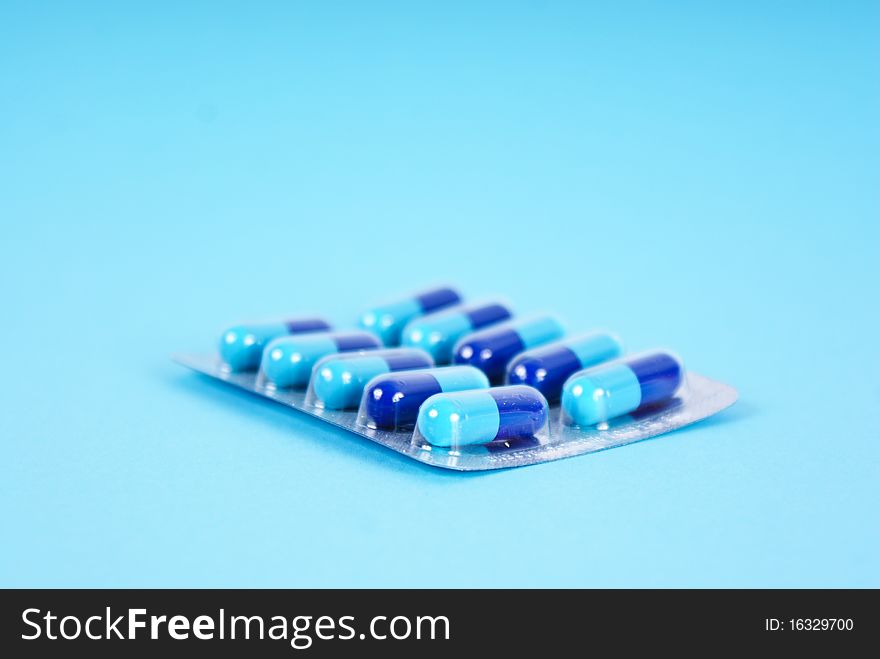 Medical tablets isolated on blue background