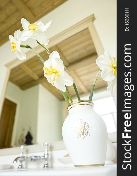Vase with flowers in the bathroom