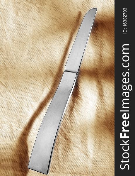 Designer knife in front of light background.