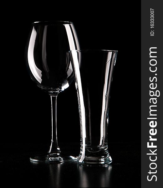 Light contour of wineglass and beerglass in dark color. Light contour of wineglass and beerglass in dark color